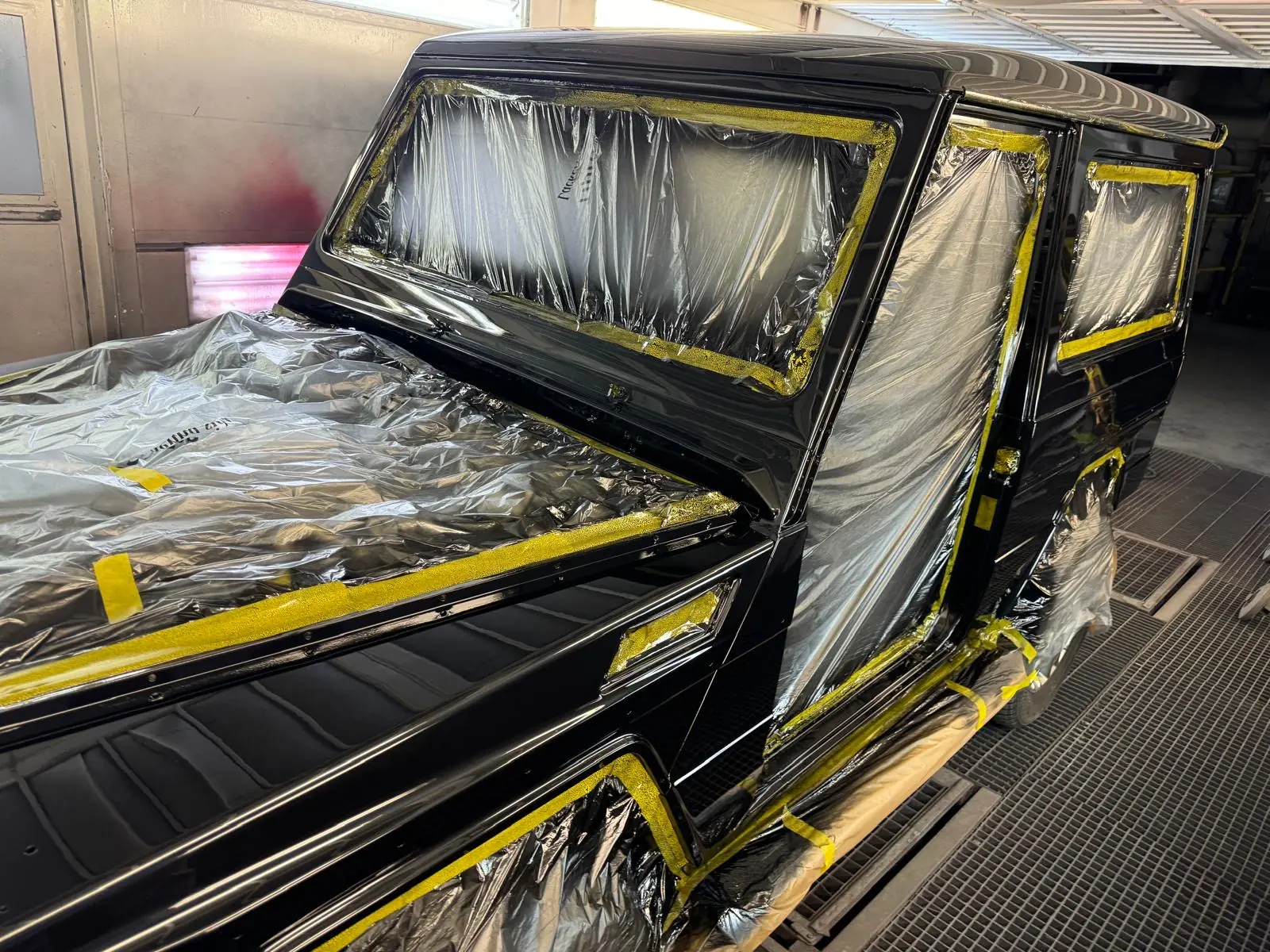 Masked off-road vehicle in the paint booth